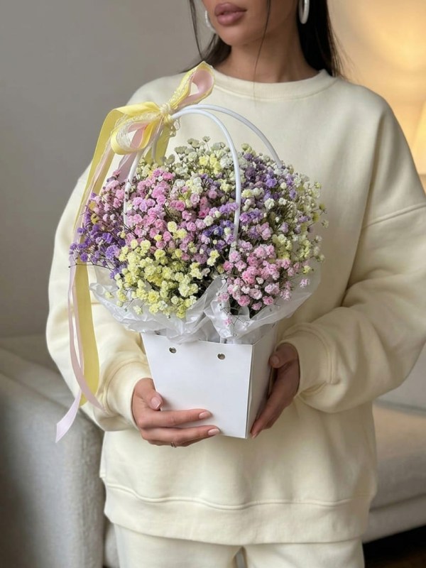 Composition of 5 branches of colored gypsophila in a flower bag