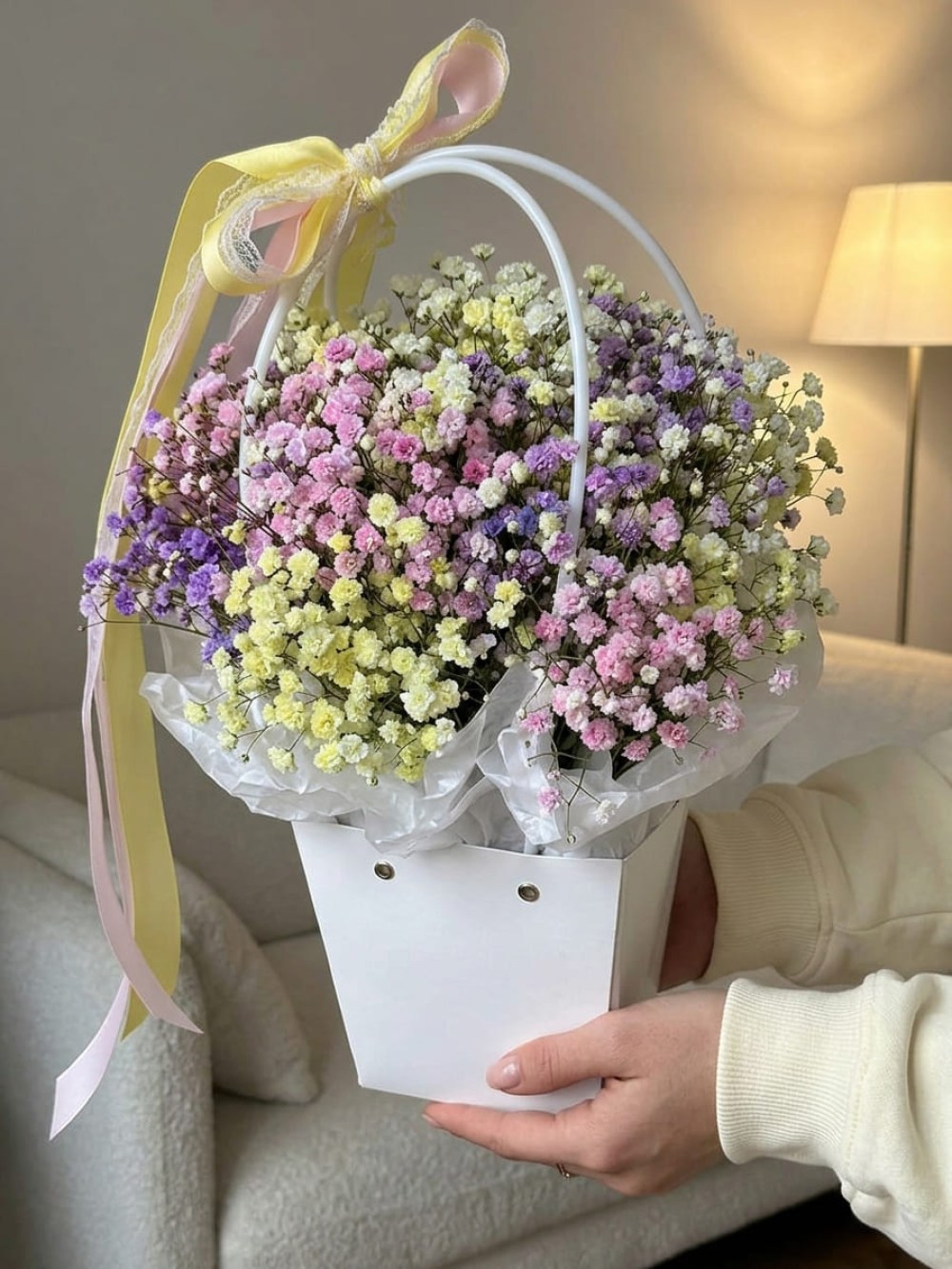 Composition of 5 branches of colored gypsophila in a flower bag
