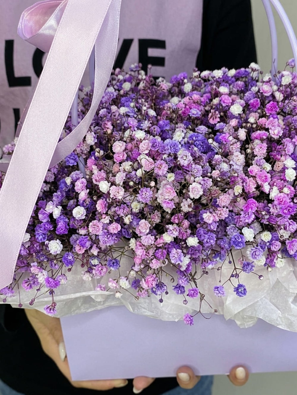 9 branches of colored gypsophila in a lilac flower bag